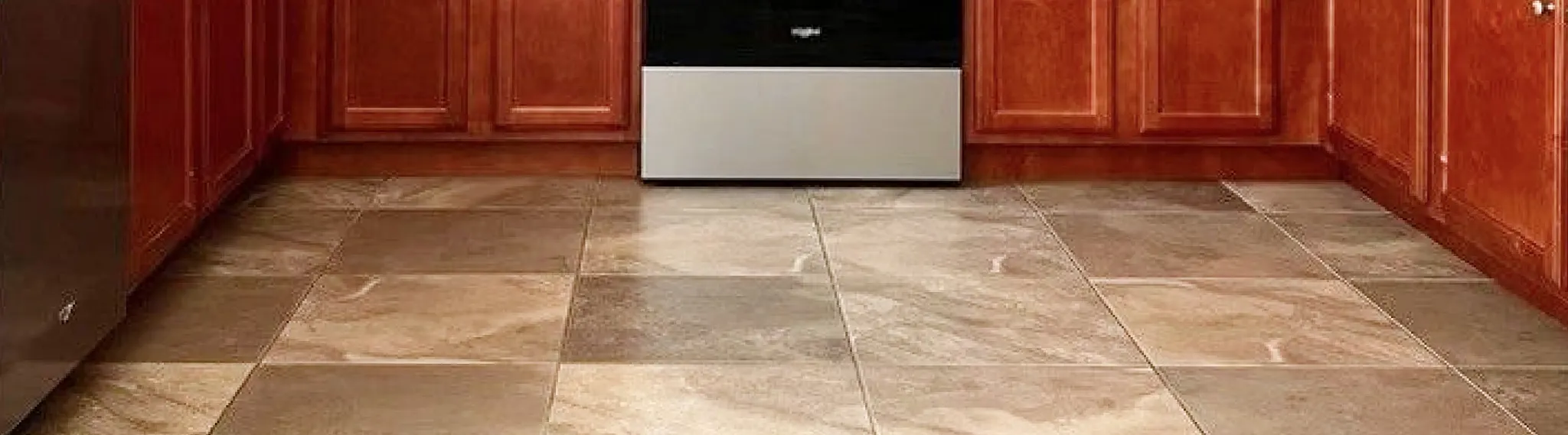 Modern kitchen with stone look luxury vinyl tile flooring in shades of beige and brown