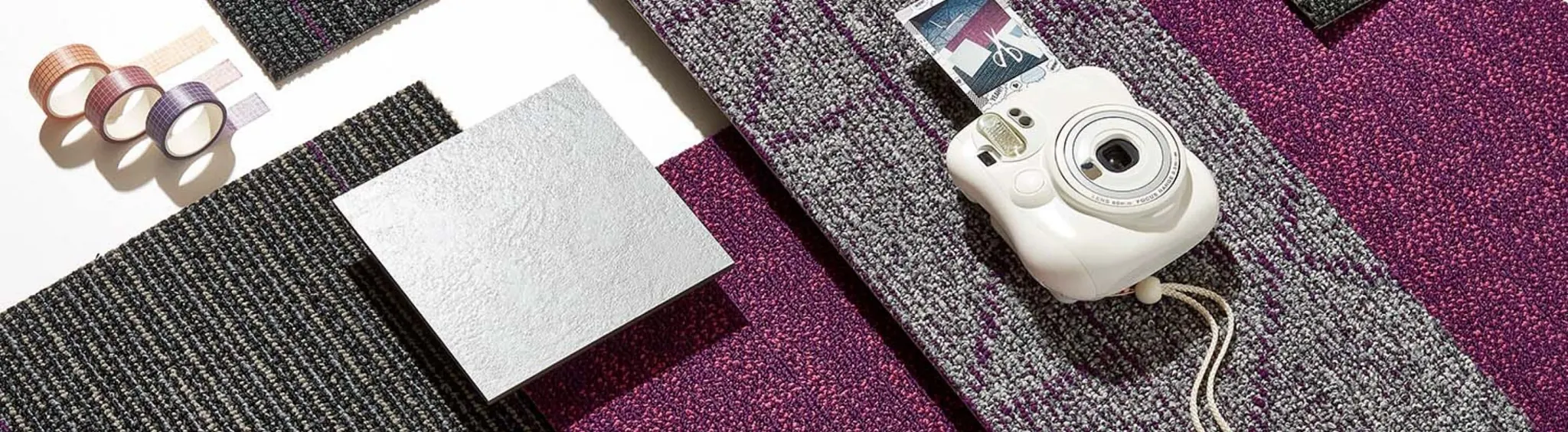Assorted carpet swatches in purple, grey, and black with camera