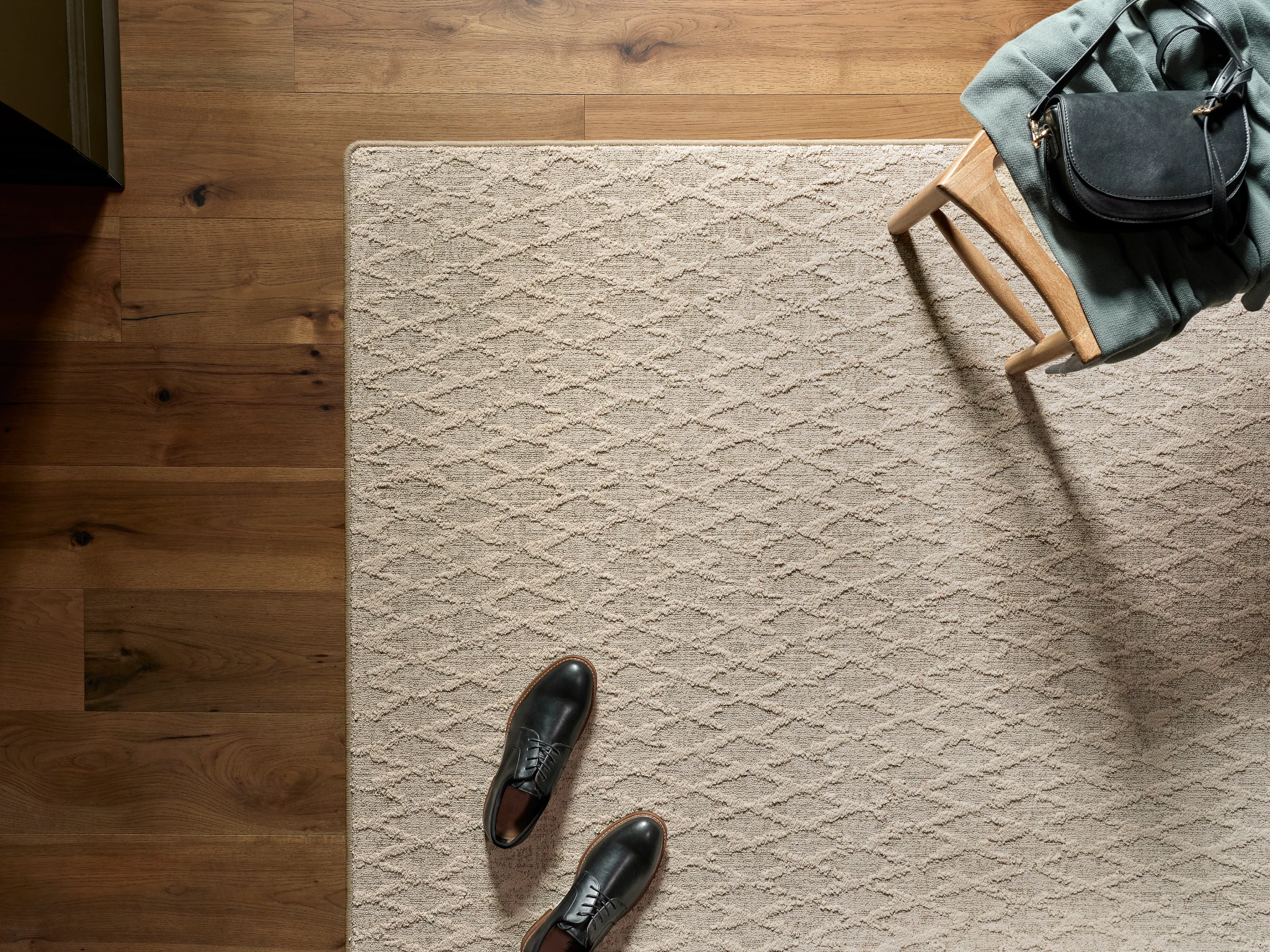 Beige textured carpet in a room with hardwood flooring
