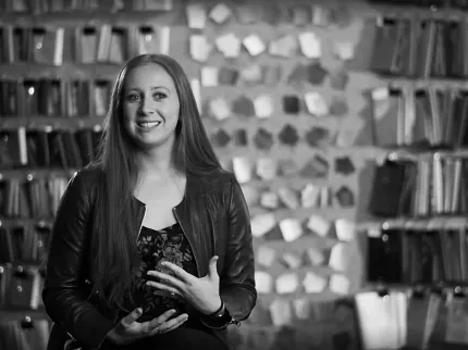 Flooring Sample Display with Woman in Leather Jacket Woman in a leather jacket sitting in front of a wall of flooring samples