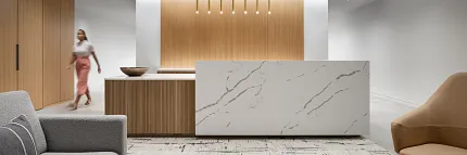 Contemporary Workplace Design with Marble and Wood Elements Modern workplace interior with a marble reception desk, wooden paneling, and contemporary furniture
