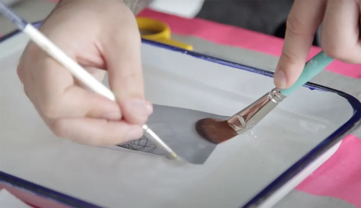 Close-up of hands painting on a tray