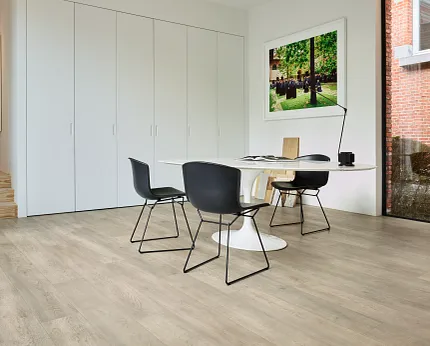 Light Wood Look Luxury Vinyl Plank Flooring in Modern Office Space Modern office space with light wood look luxury vinyl plank flooring, black chairs, and a white table