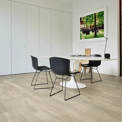 Light Wood Look Luxury Vinyl Plank Flooring in Modern Office Space Modern office space with light wood look luxury vinyl plank flooring, black chairs, and a white table