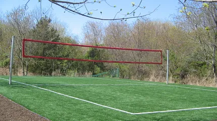 Synthetic turf volleyball court for recreational areas Outdoor artificial grass volleyball court in a park setting