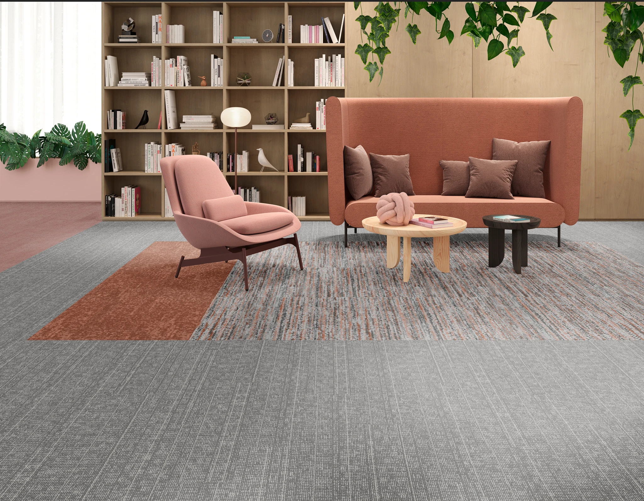 Modern lounge area with pink and gray furniture on a multi-toned gray and rust commercial carpet tile floor