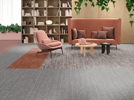 Contemporary lounge with commercial carpet tile flooring in gray and rust tones Modern lounge area with pink and gray furniture on a multi-toned gray and rust commercial carpet tile floor