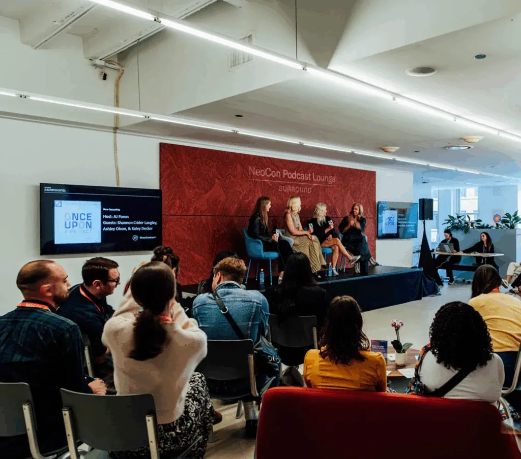 NeoCon Podcast Lounge with diverse audience and panel discussion