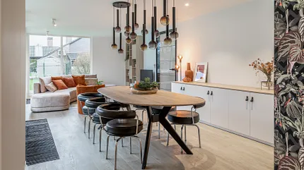 Contemporary Dining Room with Wood Look LVP Flooring Modern dining room with wood look luxury vinyl plank flooring, featuring a round table and contemporary lighting fixtures