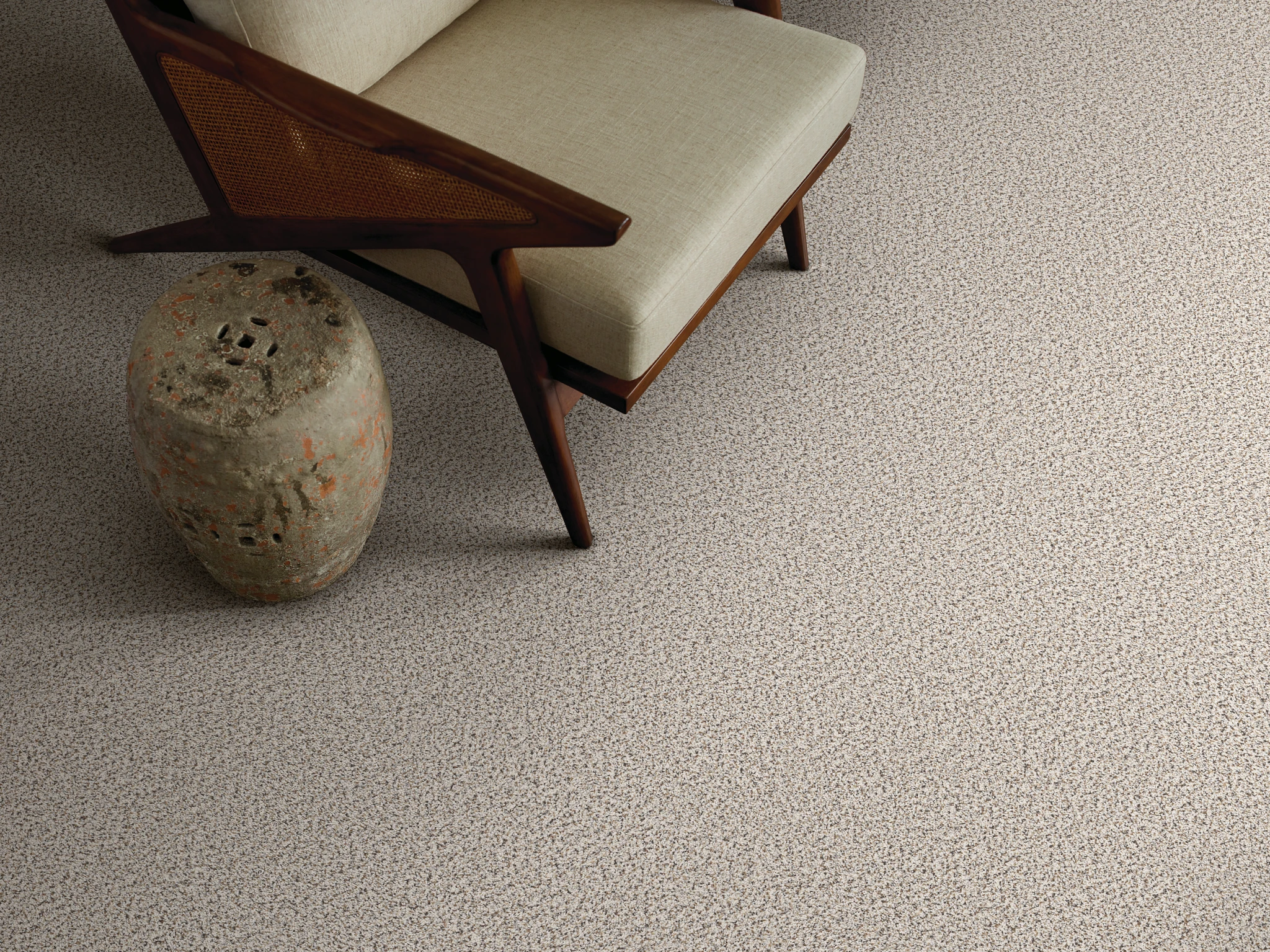 Cozy living room with a modern chair and textured beige carpet flooring