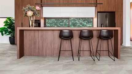 Coretec Residential SPC Stone Look Luxury Vinyl Tile Flooring in Modern Kitchen kitchen with luxury vinyl tile floor in a stone look with 2402x1201 inch tiles brown wooden cabinets and bar stools
