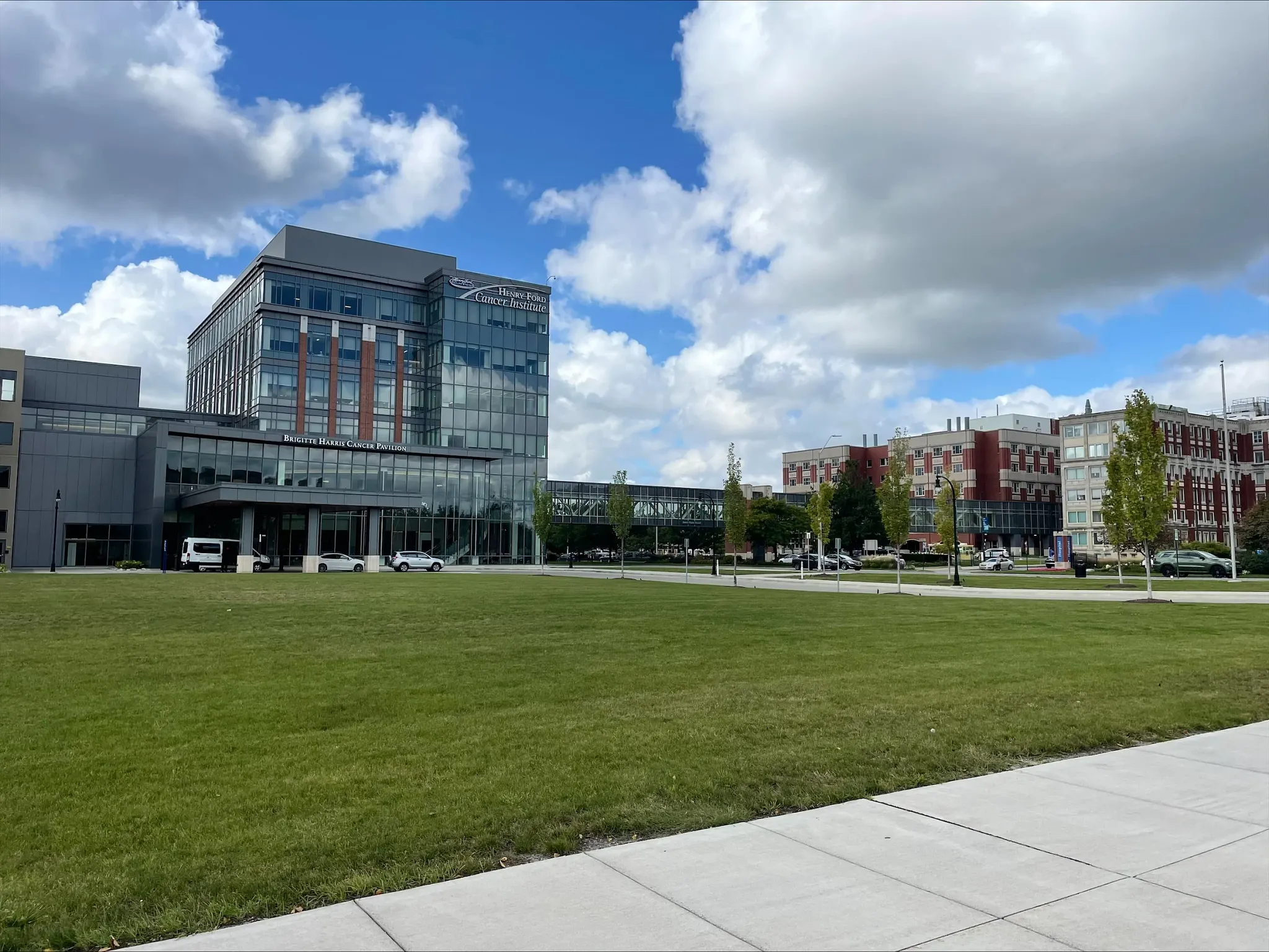 Modern building with glass facade and green lawn under blue sky