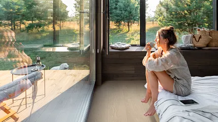 Contemporary room with luxury vinyl plank flooring and scenic view Modern living room with large windows and luxury vinyl plank flooring