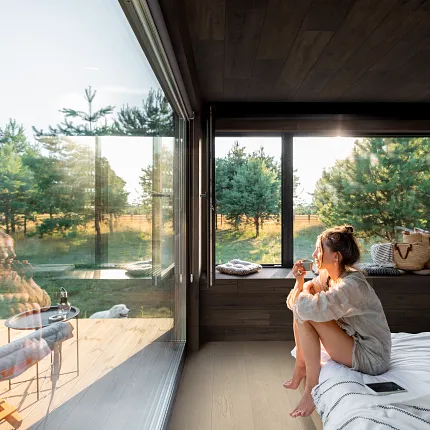 Contemporary room with luxury vinyl plank flooring and scenic view Modern living room with large windows and luxury vinyl plank flooring