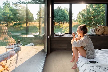 Contemporary room with luxury vinyl plank flooring and scenic view Modern living room with large windows and luxury vinyl plank flooring