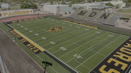 High school football field with stadium seating Aerial view of a high school football field with bleachers