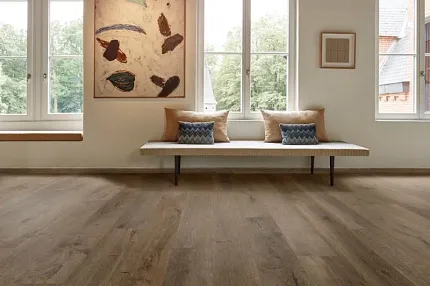 Luxury Vinyl Plank Flooring in Modern Living Room Setting Modern living room with large windows and luxury vinyl plank flooring in a natural wood look