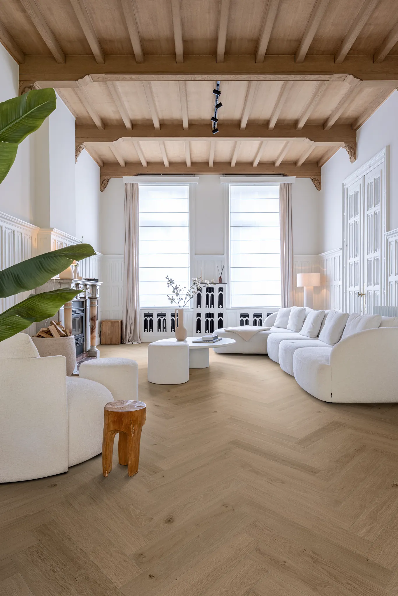 living room with luxury vinyl plank floor in a wood look design with a stylish black chair and  artwork on white brick walls