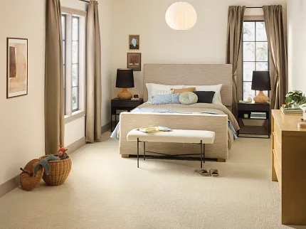Comfortable and Durable Beige Carpet Flooring for a Cozy Bedroom Cozy bedroom with beige carpet flooring, modern furniture, and natural light