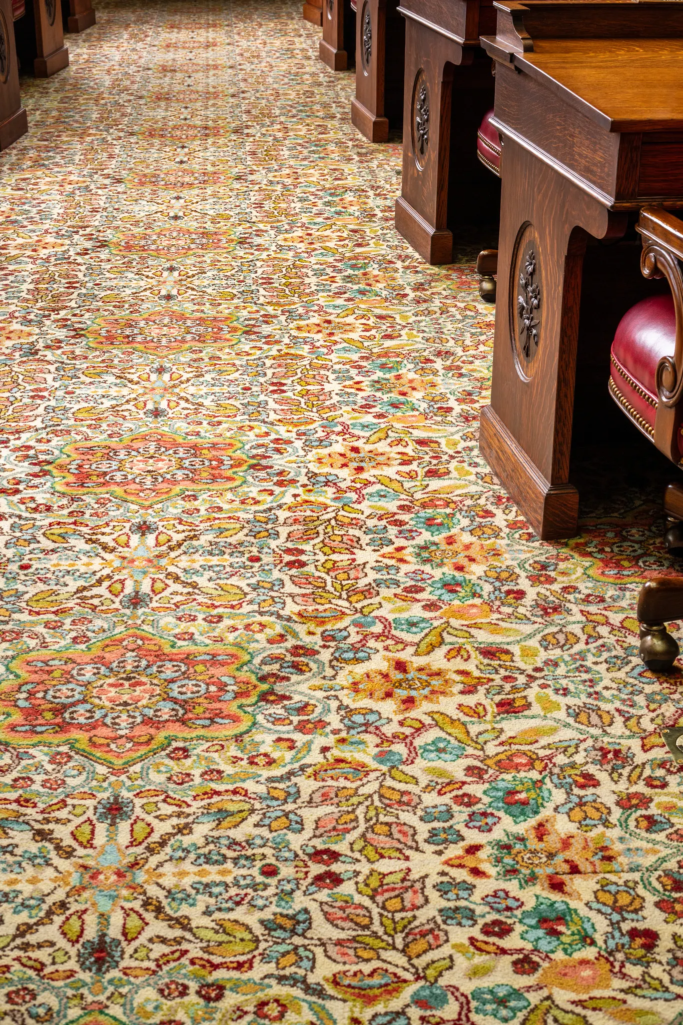 Ornate carpet with floral patterns in a traditional setting