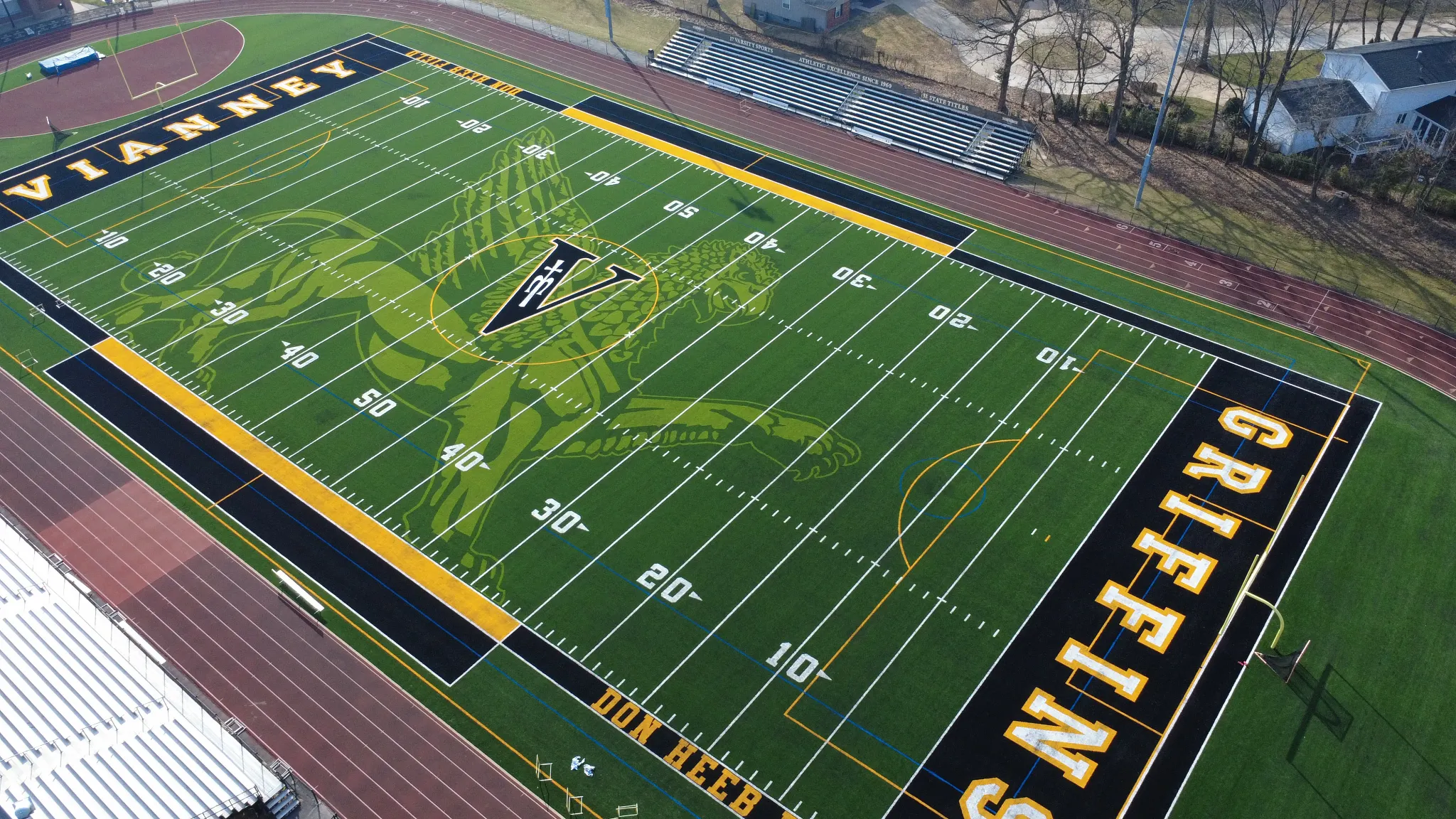 Aerial view of a football field with artificial turf featuring Vianney and Griffins logos
