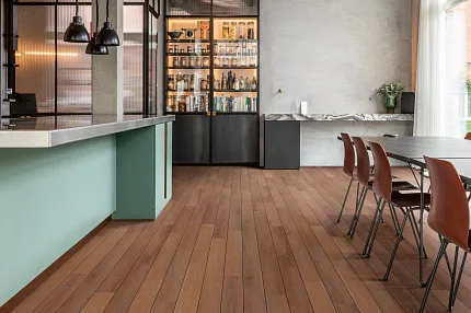 Wood Look Luxury Vinyl Plank Flooring in Modern Industrial Kitchen Scene Modern industrial kitchen with wood look luxury vinyl plank flooring, featuring exposed ductwork and contemporary furniture.