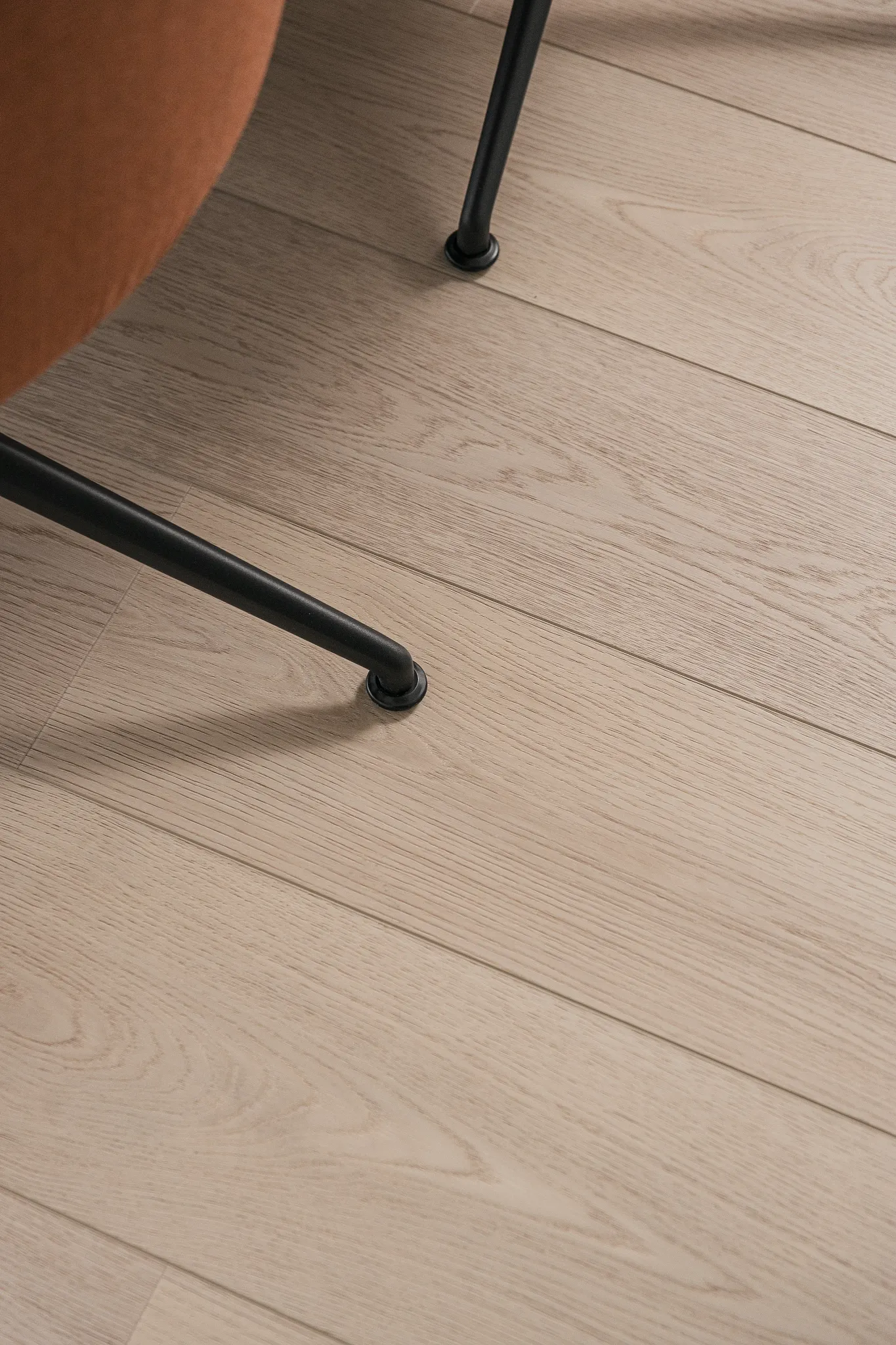 Close-up of wood look vinyl flooring with chair leg