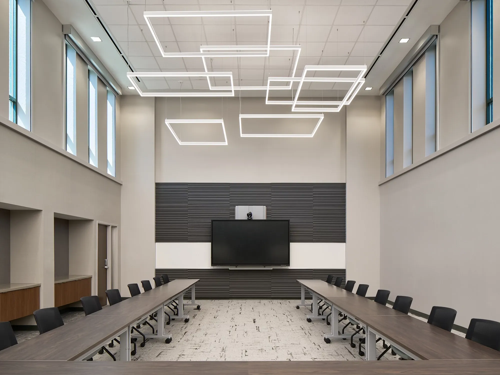 Modern conference room with sleek lighting and neutral flooring