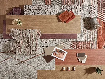 Diverse flooring options in warm, natural colors Assorted carpet and flooring samples in earthy tones