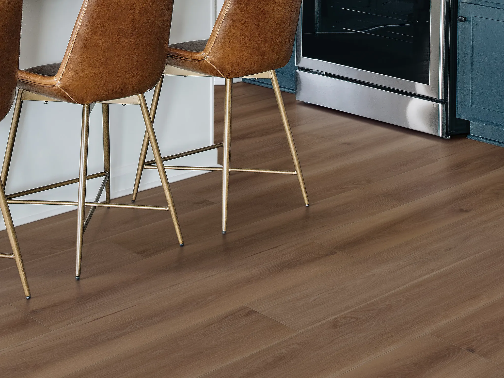 Modern kitchen with brown leather chairs and wood-look laminate flooring