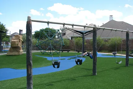 Durable artificial grass for outdoor play areas Playground with swings and artificial grass