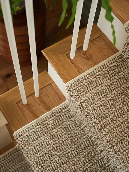 stair runner rug on wood staircase Linear patterned stair runner in a beige color on natural wood staircase