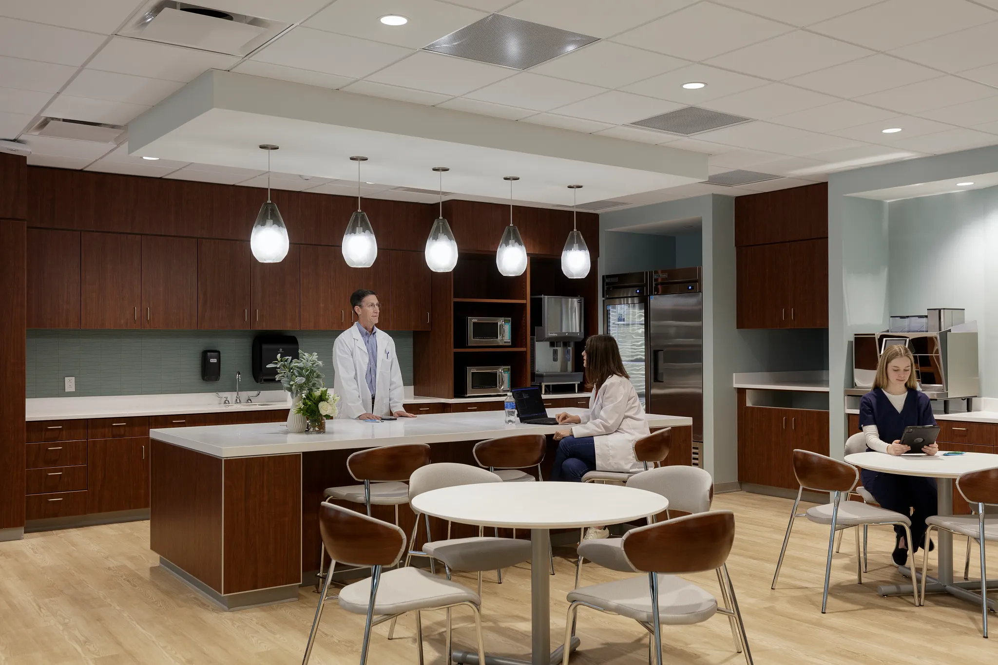 Healthcare Facility break room with wooden cabinetry, modern lighting, and light wood flooring