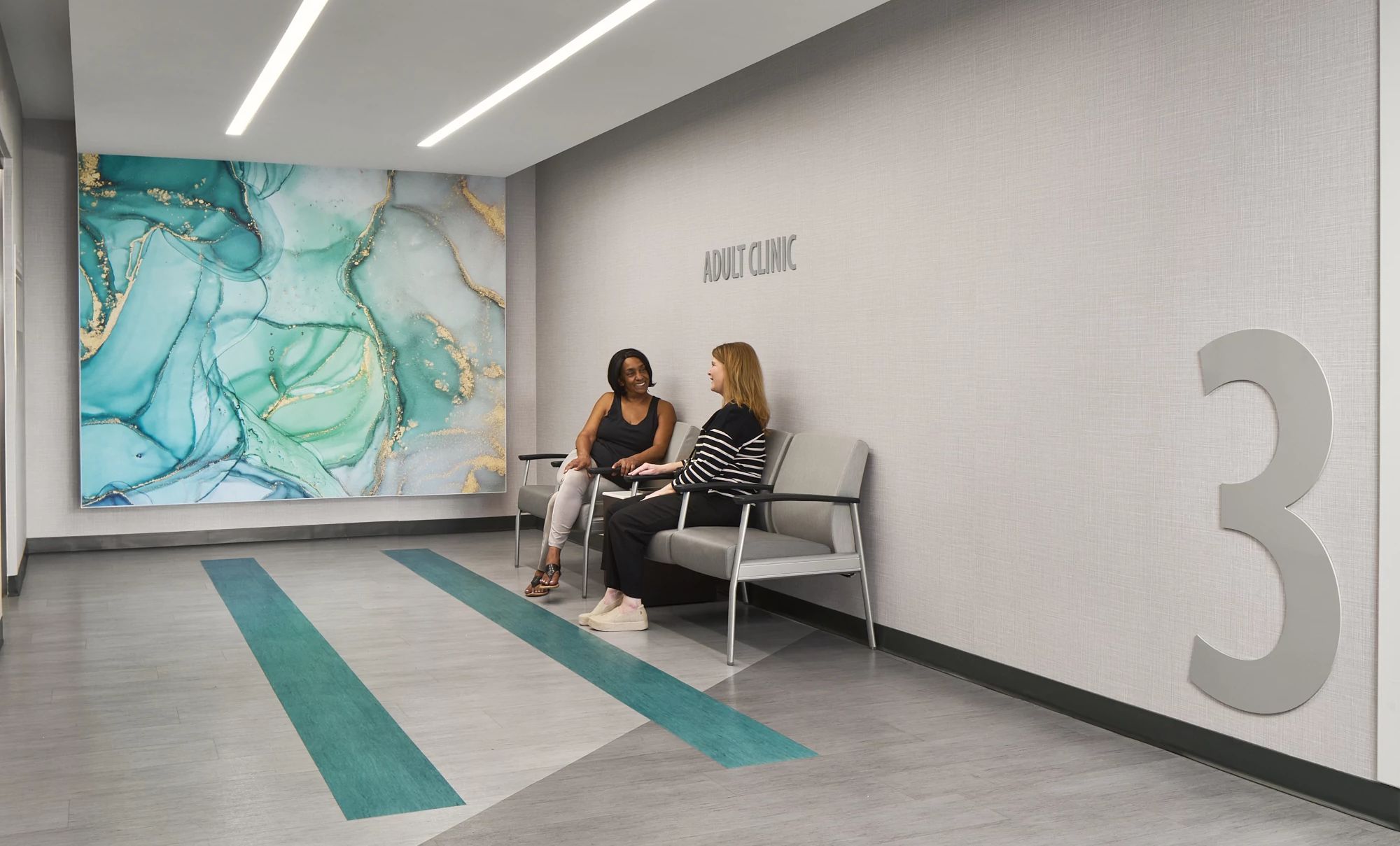 View of Grady health Ponce de Leon adult clinic with two women sitting in chairs talking