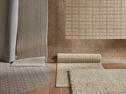 Beige and Brown Textured Carpet Collection Variety of textured carpet samples in beige and brown tones displayed in a room setting