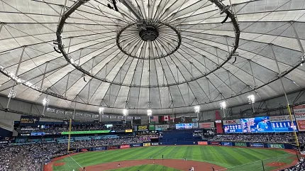 Indoor Baseball Stadium with Artificial Turf Field Indoor baseball stadium with artificial turf field and large crowd under a dome roof