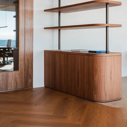 Office with wood herringbone Coretec floors in rich tones and wooden storage room
