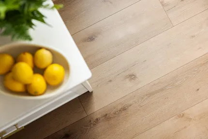 Light Wood Look LVP Flooring - 72.83x9.06 inch - Coretec Residential SPC Light wood look luxury vinyl plank flooring with lemons on a white table