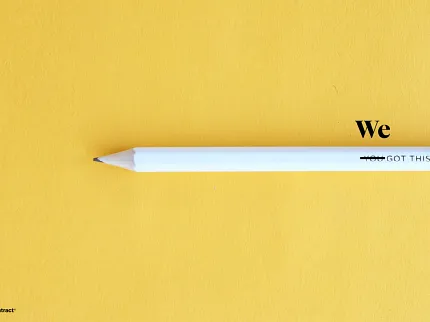 White Pencil on Yellow Background with Motivational Text White pencil on yellow background with text "We Got This"
