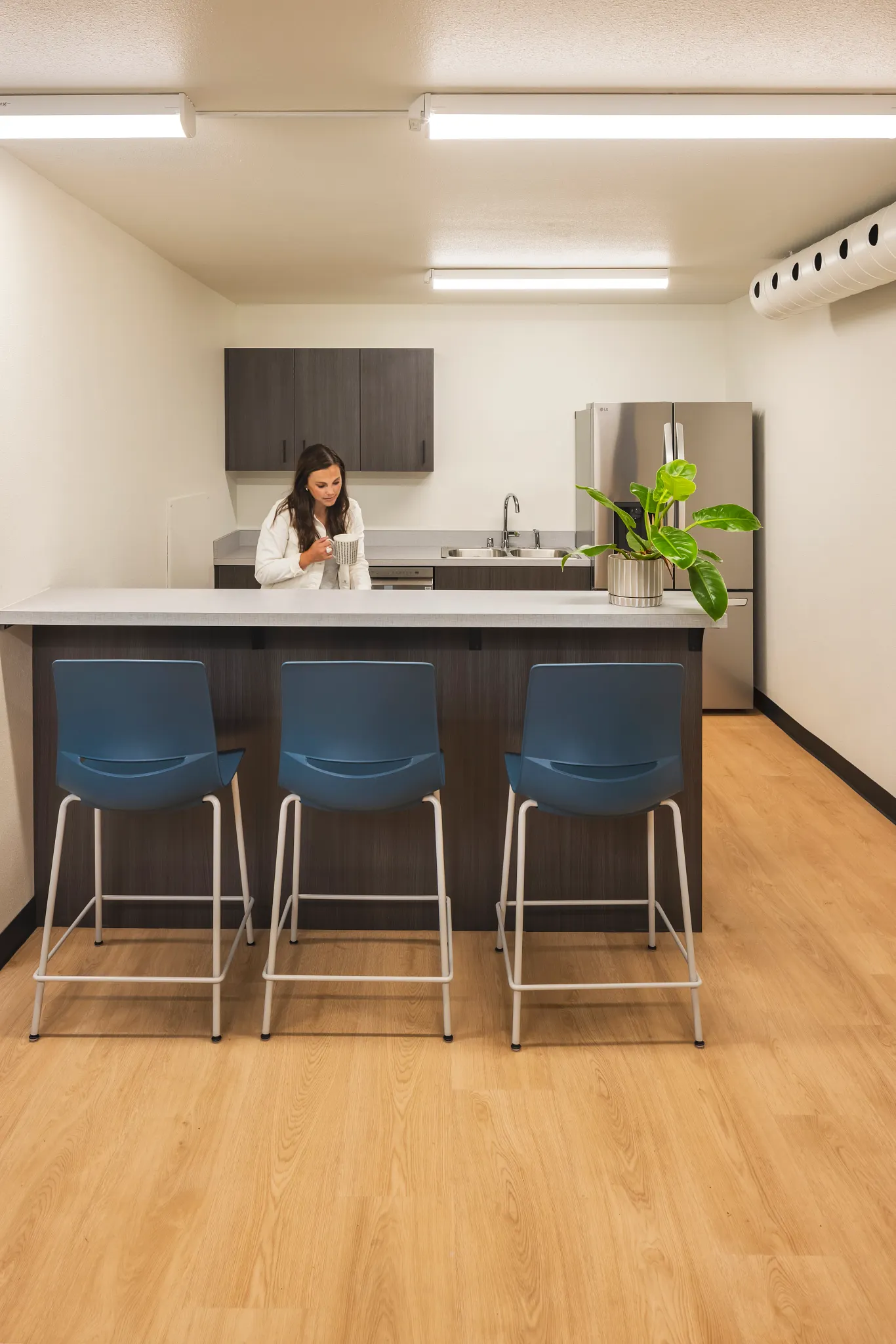 Modern kitchen area in an education facility with heavy commercial PVC-free EcoWorx resilient flooring, featuring a light wood finish and dimensions of 50.79x8.27 inches