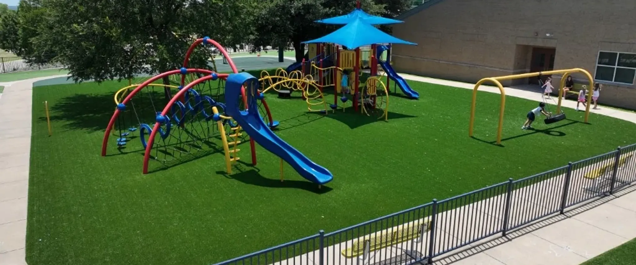 Playground with artificial grass and colorful equipment