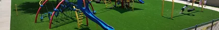 Playground with artificial grass and colorful equipment