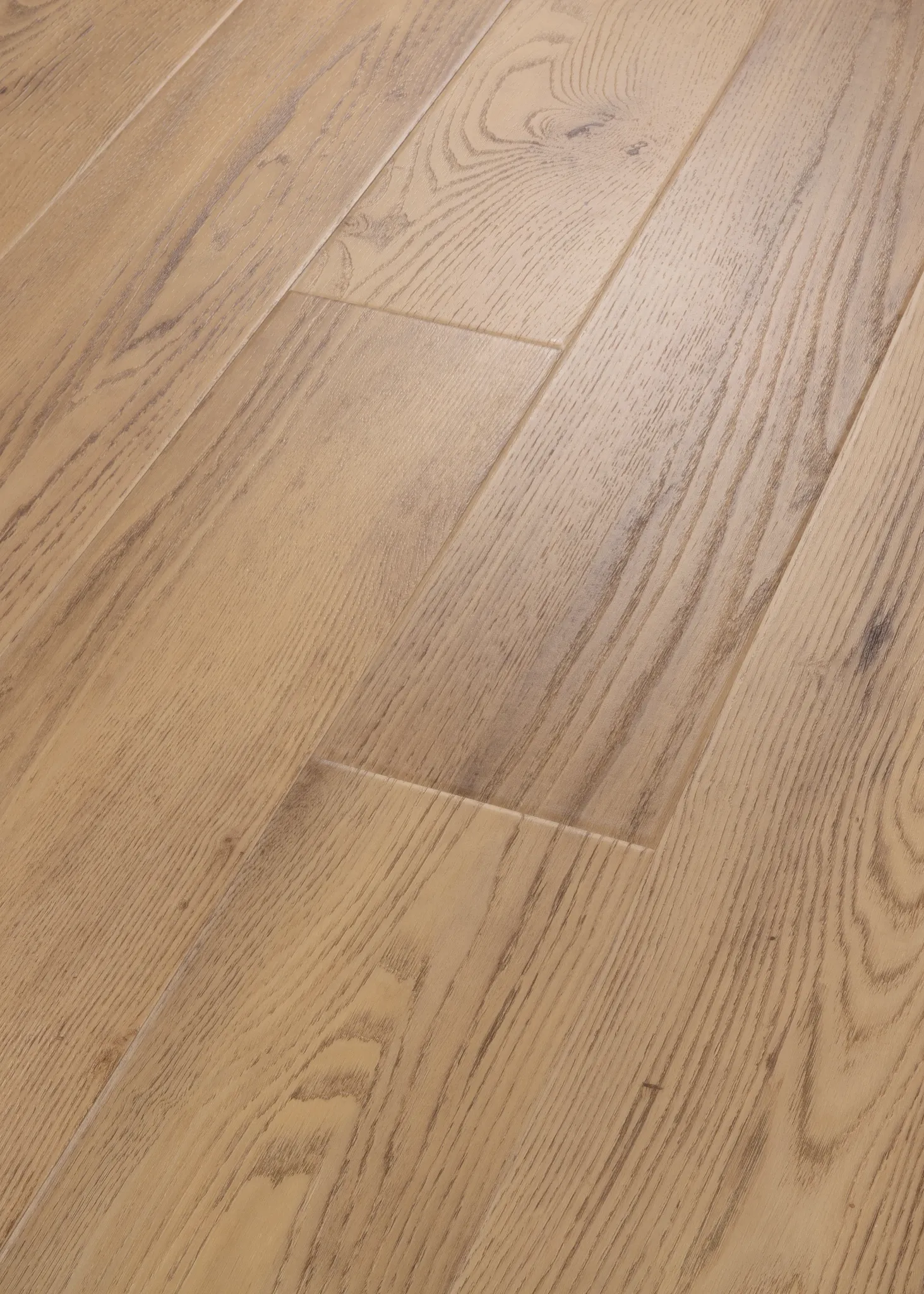 Close-up of light oak engineered hardwood flooring showcasing natural wood grain and texture