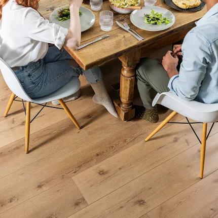 Coretec Residential SPC Luxury Vinyl Plank Flooring - Natural Wood Look, 72.83x9.06 inch Dining room scene with young couple enjoying a meal on Coretec Residential SPC luxury vinyl plank flooring in a natural wood look, 72.83x9.06 inch dimensions