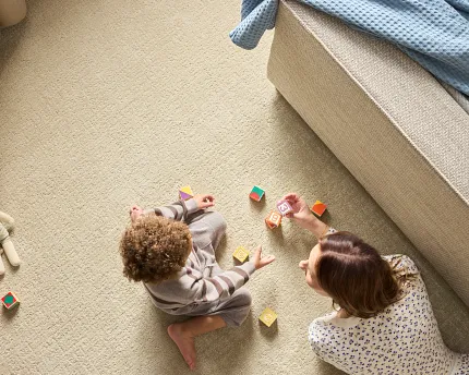 Comfortable and durable beige carpet for family living spaces Cozy family room with children playing on soft beige carpet