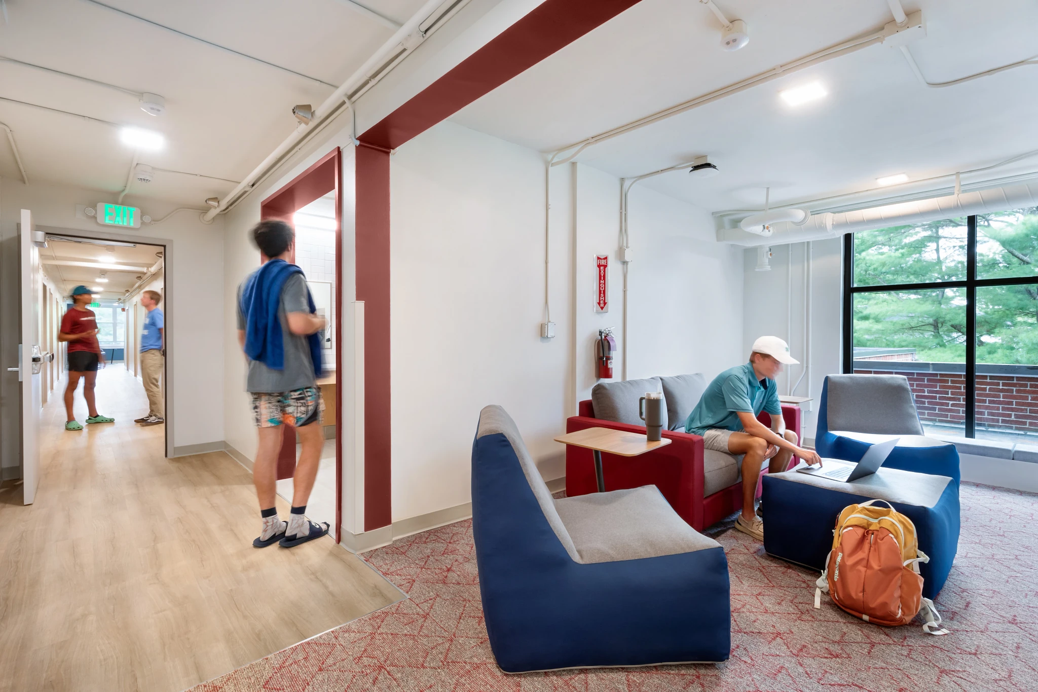 Education facility lounge area with modern seating and light wood flooring