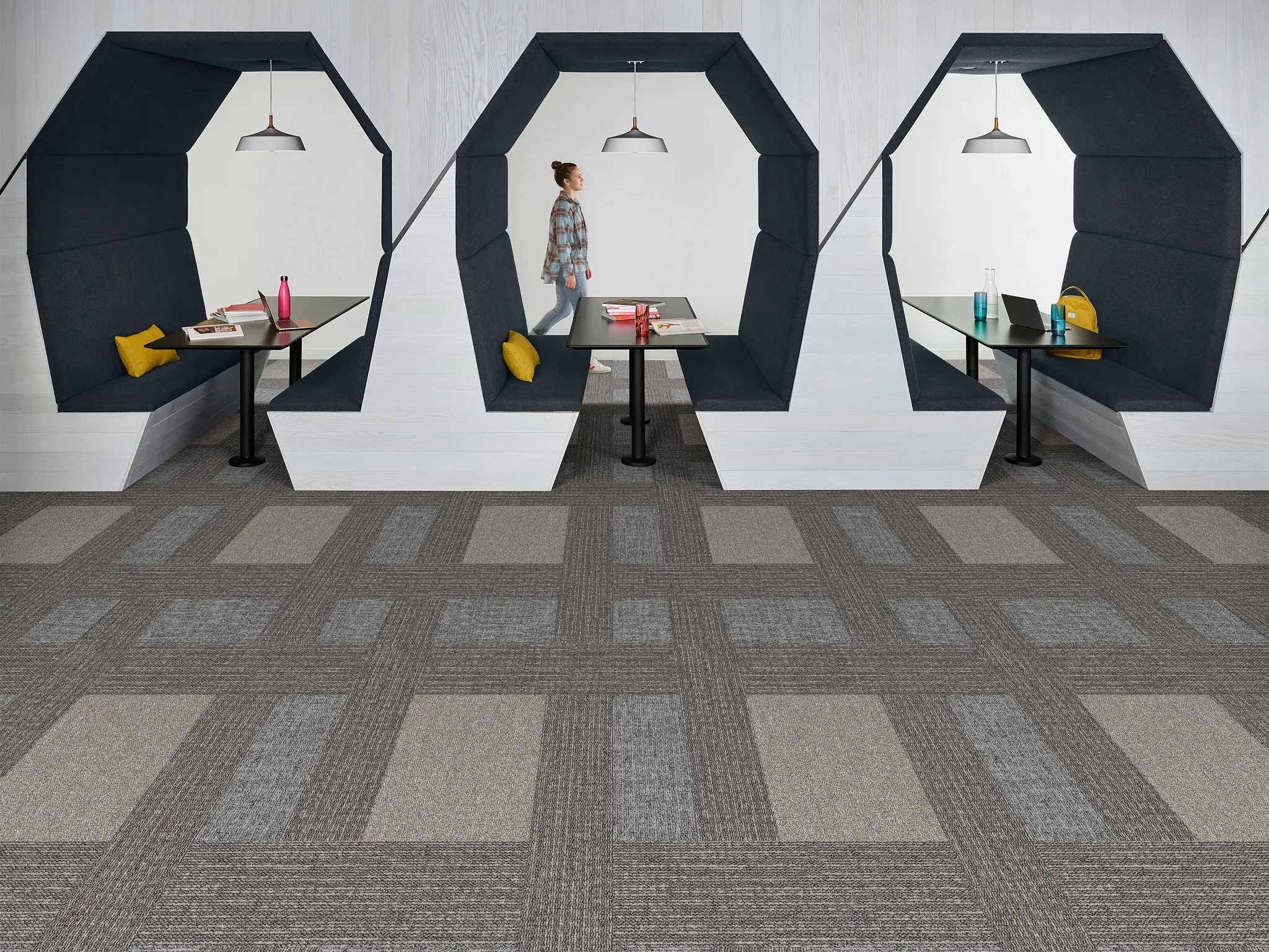 Modern education facility with geometric seating and commercial carpet tile flooring in shades of gray