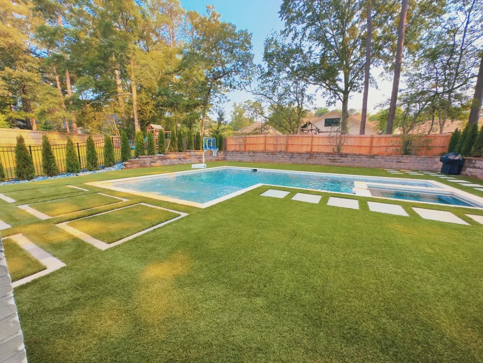 Backyard with artificial grass and swimming pool