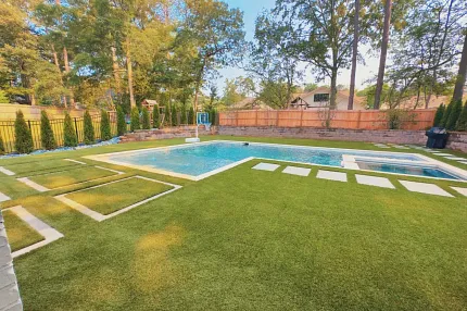Modern outdoor space with synthetic turf and pool Backyard with artificial grass and swimming pool