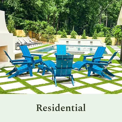 Stylish residential outdoor seating area with pool Outdoor patio with blue chairs and checkerboard grass tiles